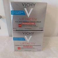 Front view of two stacked boxed creams showing product name and size