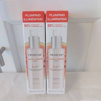 Front view of both boxed creams