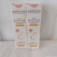 Front view of two boxed Embryolisse Radiant Complexion Creams