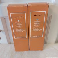 Front view of both boxed cleansers