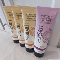 Group shot of four Vitabath body cream tubes standing upright
