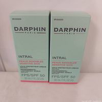 Front view of two sealed Darphin Intral SPF 50 emulsion boxes