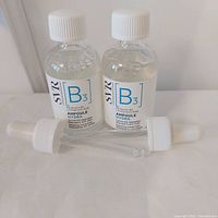 Two SVR [B3] Ampoule Hydra bottles with loose droppers on white surface