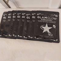 Eight Glamglow Bubblesheet masks laid out front view