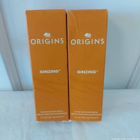 Front view of both boxed Origins GinZing serums