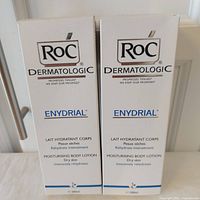 Front view of two boxed RoC Dermatologic Enydrial 200 ml lotions