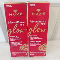 Front view of two sealed Nuxe Merveillance Lift Glow Cream boxes