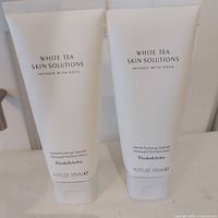 Front view of two sealed Elizabeth Arden White Tea Skin Solutions Gentle Purifying Cleanser tubes 125 ml