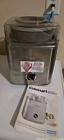 Front view of Cuisinart ICE-30 ice cream maker with booklet