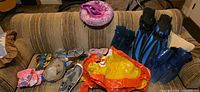Overview of lot on sofa showing fins, masks, floats, water shoes