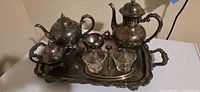 Front angled view of full silver plated set on tray