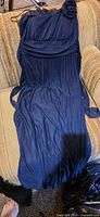 Navy one-shoulder pleated formal dress with flower detail