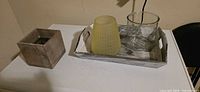 Tray, yellow frosted planter, clear glass vase, square wood planter overview