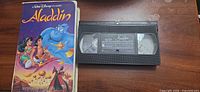 Front of Aladdin clamshell case and VHS cassette