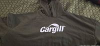 Front view showing Cargill logo on olive hoodie