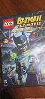 Front of sealed DVD case showing title and LEGO superhero artwork