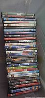 Stack of about 34 DVD cases with visible titles