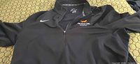 Front view showing Nike swoosh, Princeton Athletics embroidery, quarter-zip, collar