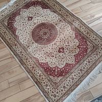Full view of silk area rug on wood floor