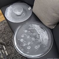 Textured platter with dip bowl and floral platter side by side on sofa