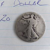 Obverse of 1920 Walking Liberty Half Dollar on paper background
