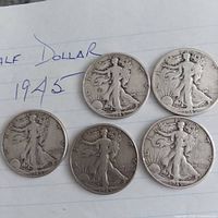 Five obverse sides of 1945 Walking Liberty half dollars