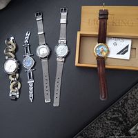 All five watches laid out side by side