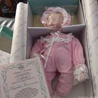 Doll in box with certificate of authenticity visible