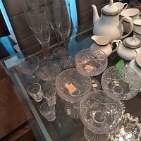 Group of Ukrainian glassware on table showing flutes, coupes, cordial glasses and cut crystal bowls