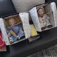 Both boxed dolls side by side showing outfits and packaging