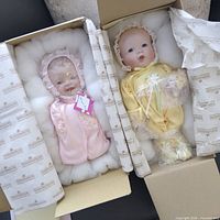 Both boxed dolls side by side showing packaging and outfits