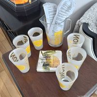 Pitcher, four tumblers, insert card on tabletop