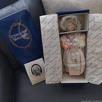Box with Children from Mother Goose branding, doll visible inside packaging, brochure