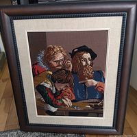 Full view of framed needlepoint artwork showing frame, mat and stitched scene