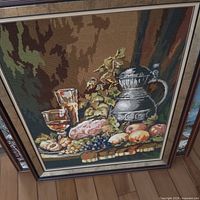 Front view of framed needlepoint showing entire artwork and frame