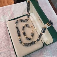 Necklace and bracelet set displayed in green Napier case