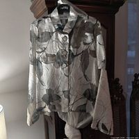 Front view of Joseph Ribkoff leaf-print blouse-jacket showing buttons, collar, and pattern