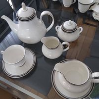 Group view showing coffee pot, sugar bowl, creamer, gravy boat, teacup and saucer