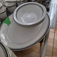 Top view of oval platter with stacked serving bowls in Sarabande pattern