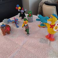 Group shot of seven Sesame Street figurines on surface