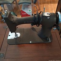 Left side view of Seamstress Rotary sewing machine mounted in cabinet