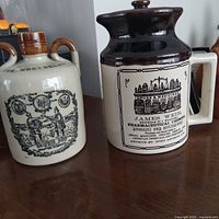 Front view of both stoneware advertising jugs
