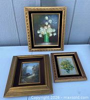 Group shot of three framed artworks