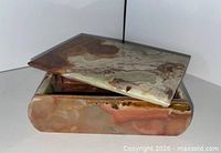 Box with lid slightly open showing exterior coloration