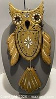 Front view of painted wooden owl wall hanging