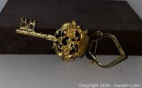 Gold-tone skeleton key brooch scarf clip, front view