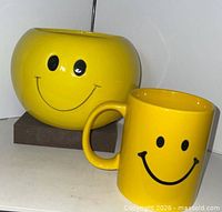 Planter and mug front view showing smile graphics
