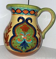 Front view of Maxcera Talavera pitcher showing floral motif and handle