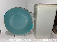 Round teal item beside off-white rectangular container
