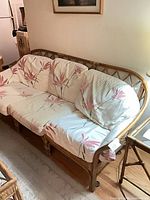 Full view of rattan sofa with cushions